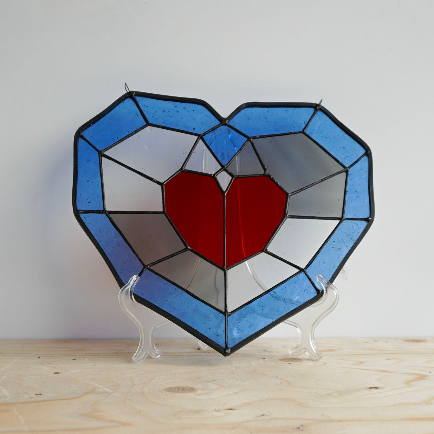 piece of heart stained glass on display stand front view